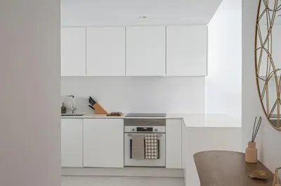 a kitchen with white cabinets and a stove at Madeira Aqua Dream in Funchal