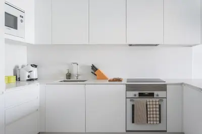 a kitchen with white cabinets and a stove top oven at Madeira Aqua Dream in Funchal