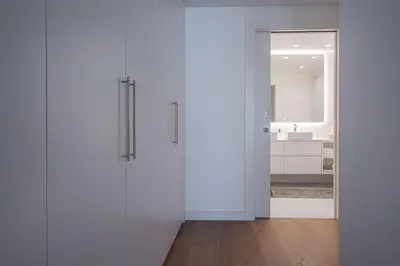 a bathroom with white walls and a white sink at Madeira Aqua Dream in Funchal
