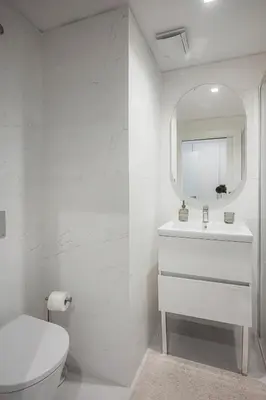 a white bathroom with a toilet and a mirror at Madeira Aqua Dream in Funchal