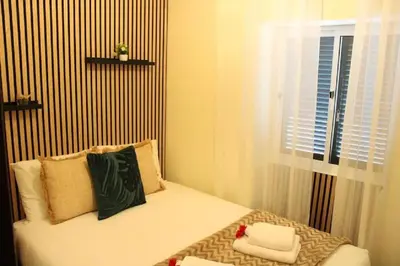 a bedroom with a bed with two night stands and two lamps at Casa da Guiomarinha in Seixal
