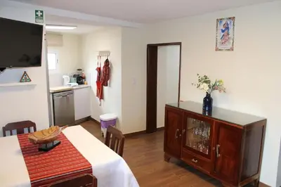 a living room with a table and a blue couch at Casa da Guiomarinha in Seixal