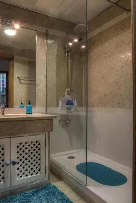 a bathroom with a shower and a tub and a sink at Monumental Apartment in Funchal