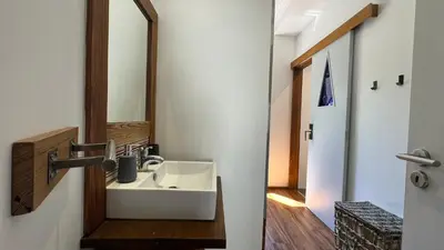 a bathroom with a sink and a mirror at The Modern & Recycled House in Machico