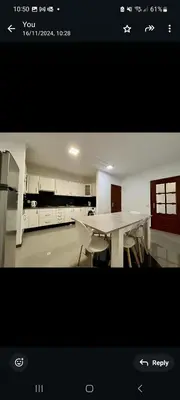 a view of a kitchen with a table and chairs at Geovanny house in Funchal