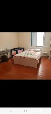 a bed in a room with a wooden floor at Geovanny house in Funchal