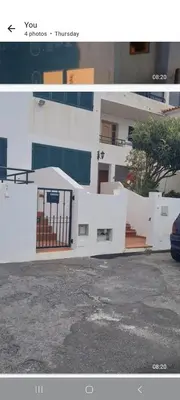 a white building with a gate in front of it at Geovanny house in Funchal