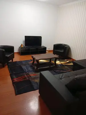 a living room with a table and two chairs at Geovanny house in Funchal