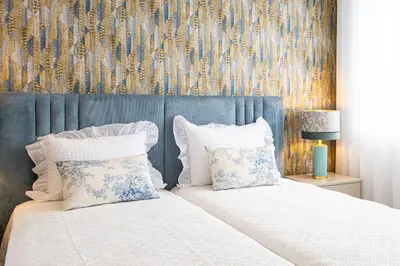 a bedroom with a bed with two pillows at Casa Graminho in Ponta do Sol