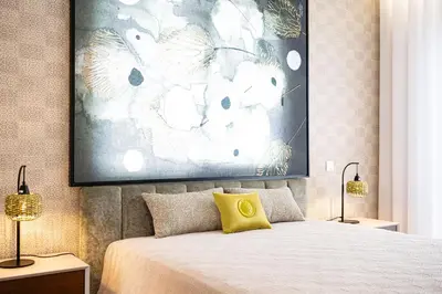a bedroom with a bed with a yellow pillow on it at Casa Graminho in Ponta do Sol