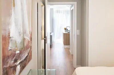 a hallway with a bed and a painting on the wall at Casa Graminho in Ponta do Sol