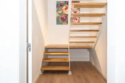 a staircase with wooden steps in a room at Casa Graminho in Ponta do Sol