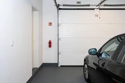 a garage with a car parked next to a garage door at Casa Graminho in Ponta do Sol