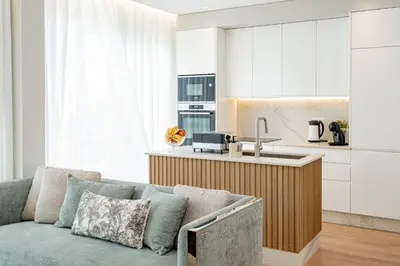 a living room with a couch and a kitchen at Casa Graminho in Ponta do Sol