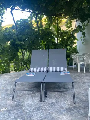 a blue bench sitting on top of a patio at Traditional Madeira House Garden, Terrace & BBQ in Ribeira Brava