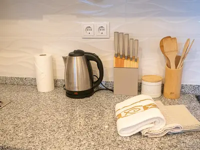 a kitchen counter with a tea kettle and utensils at Traditional Madeira House Garden, Terrace & BBQ in Ribeira Brava