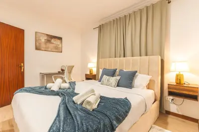 a bedroom with a large bed with blue pillows at Stero House by Atlantic Holiday in Caniçal