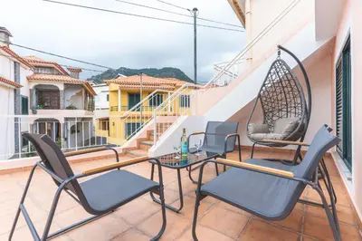 a patio with chairs and a table on a balcony at Stero House by Atlantic Holiday in Caniçal