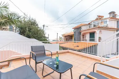 a patio with chairs and a table on a balcony at Stero House by Atlantic Holiday in Caniçal