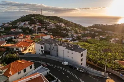 an aerial view of a city with the ocean at Saraiva Hills II by An Island Apart in Câmara de Lobos