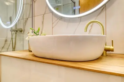 a white bowl sink on a wooden counter in a bathroom at Alzira's Place, a Home in Madeira in Ponta do Sol