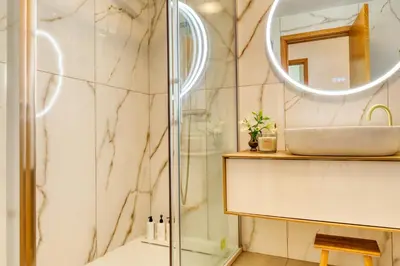 a bathroom with a sink and a mirror at Alzira's Place, a Home in Madeira in Ponta do Sol
