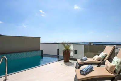 a balcony with a swimming pool on top of a building at Villa Joy, moderna e sofisticada in Funchal