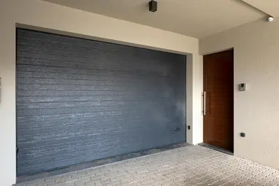 a garage door in a house with a wooden door at Villa Joy, moderna e sofisticada in Funchal