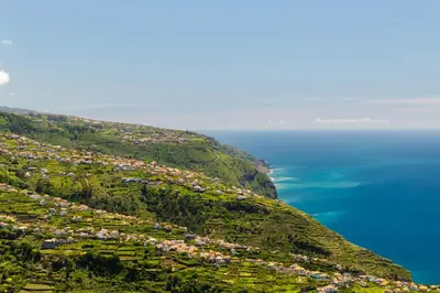 an aerial view of a town on a hill next to the ocean at Casa do Paulinhos - Vista Panorâmica, Natureza, Wi-Fi Rápido in Estreito da Calheta