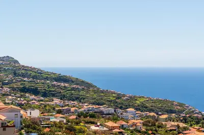 a town on a hill next to the ocean at Casa do Paulinhos - Vista Panorâmica, Natureza, Wi-Fi Rápido in Estreito da Calheta