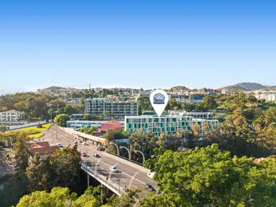 an aerial view of a city with a large building at Vista Savoy Apartamento in Funchal