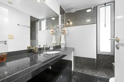 a bathroom with a sink and a mirror at Vista Savoy Apartamento in Funchal