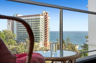 a balcony with a table and a view of the ocean at Vista Savoy Apartamento in Funchal