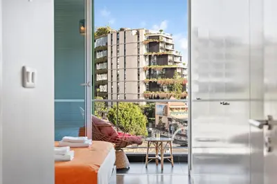 a living room with a view of a tall building at Vista Savoy Apartamento in Funchal