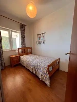 a bedroom with a bed and a lamp in it at Private Oceanfront Cottage with 180 degree Sea View, 100 m Terrace in Funchal