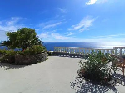 a balcony with a view of the ocean at Private Oceanfront Cottage with 180 degree Sea View, 100 m Terrace in Funchal