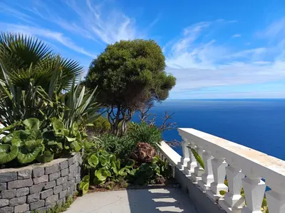 a view of the ocean from a balcony at Private Oceanfront Cottage with 180 degree Sea View, 100 m Terrace in Funchal
