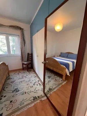 a room with a bed and a door leading to a bedroom at Private Oceanfront Cottage with 180 degree Sea View, 100 m Terrace in Funchal