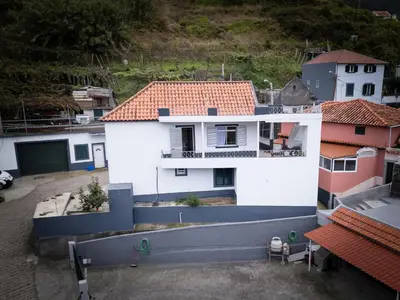 an aerial view of a white building with red roofs at Til s Place in São Vicente