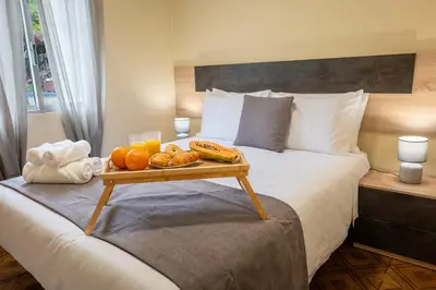 a bed with a tray of food on top of it at Til s Place in São Vicente
