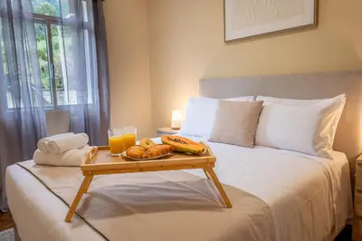 a bed with a tray of food on top of it at Til s Place in São Vicente