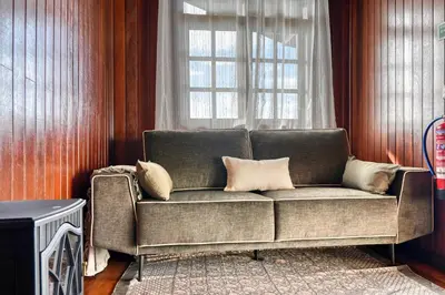 a couch in a living room with a window at Chalet do Relógio d'Água, a Home in Madeira in Ponta do Sol