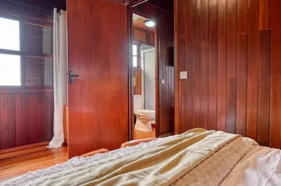 a bedroom with a bed and a toilet in a room at Chalet do Relógio d'Água, a Home in Madeira in Ponta do Sol