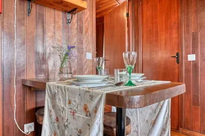 a table with plates and glasses on top of it at Chalet do Relógio d'Água, a Home in Madeira in Ponta do Sol