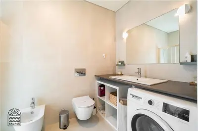 a bathroom with a washing machine and a sink at Good Times Sagres in Sagres