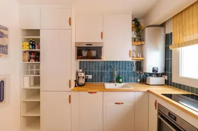 a kitchen with white cabinets and a sink at Casa Phoebe - NEW Renovated Burgau Apartment Sleeps 5 - Beach 1 min in Burgau
