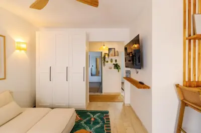 a living room with a white couch and a refrigerator at Casa Phoebe - NEW Renovated Burgau Apartment Sleeps 5 - Beach 1 min in Burgau