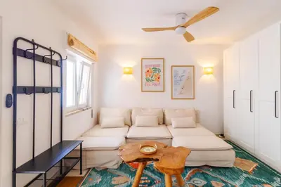 a living room with a couch and a table at Casa Phoebe - NEW Renovated Burgau Apartment Sleeps 5 - Beach 1 min in Burgau