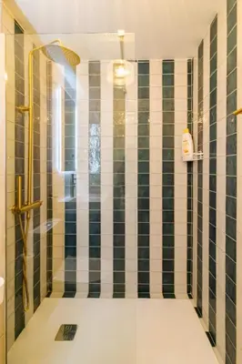 a bathroom with a shower with black and white tiles at Casa Phoebe - NEW Renovated Burgau Apartment Sleeps 5 - Beach 1 min in Burgau