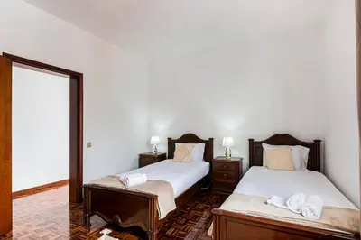 a bedroom with two beds and a mirror at Villa do Carmo by GALMI in Funchal